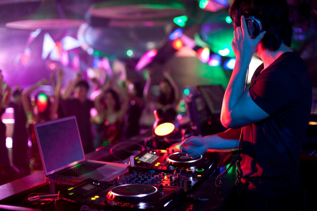 DJ doing record Scratching in nightclub